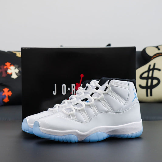 Air Jordan 11  Retro Legend Blue 2011. 
White sneakers with blue accents in front of a Jordan box