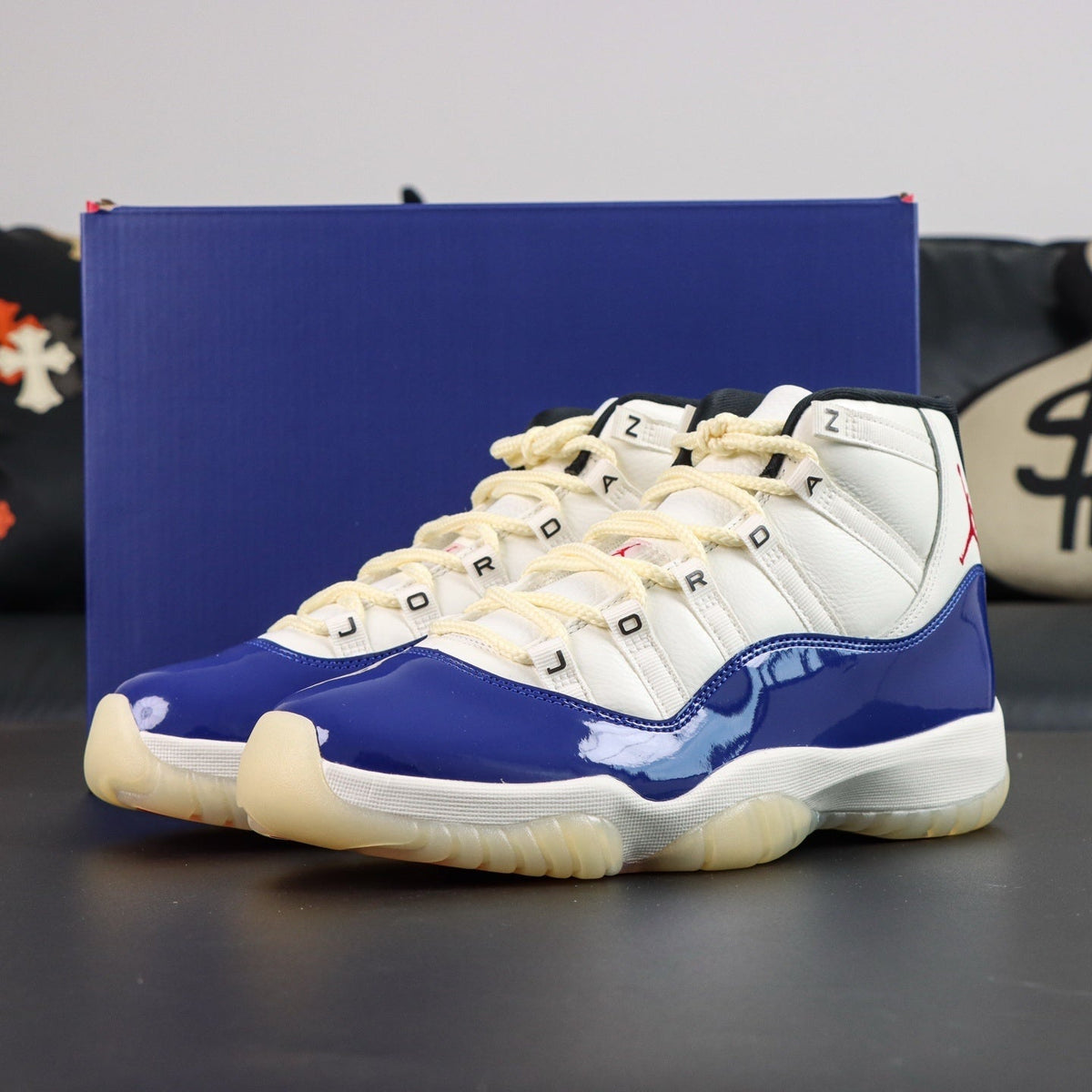 Air Jordan 11  Retro Rare Air 2025. Blue and white sneakers with beige laces on a dark surface