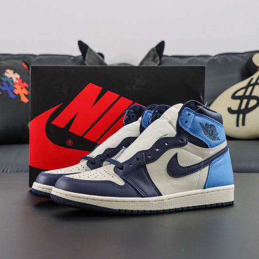 Air Jordan 1 Retro High OG Obsidian. Blue and white sneakers with a black and red Nike box in the background. 